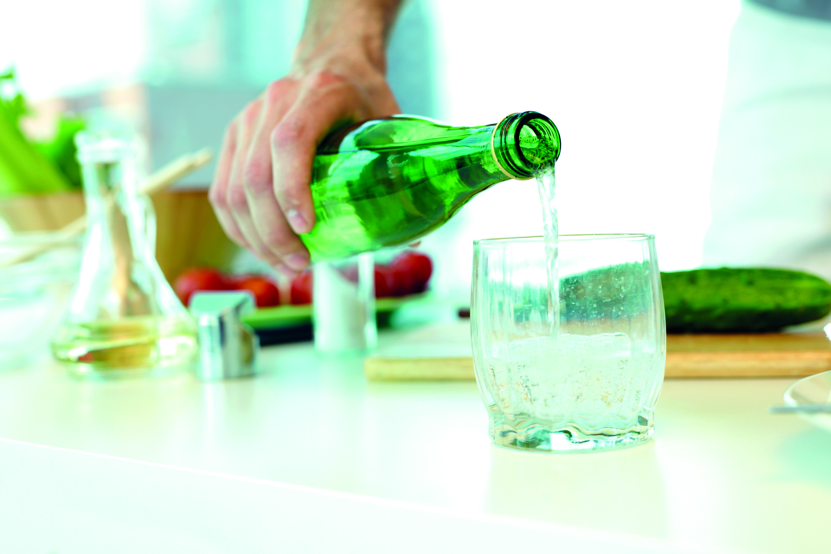 Man pouring mineral water in glass